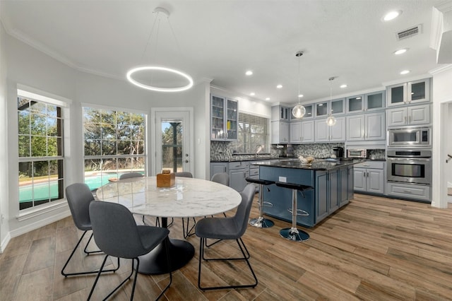 9288 Scenic Bluff Dr, Austin, TX 78733 - dining space featuring ornamental molding, wood finished floors, recessed lighting, and baseboards