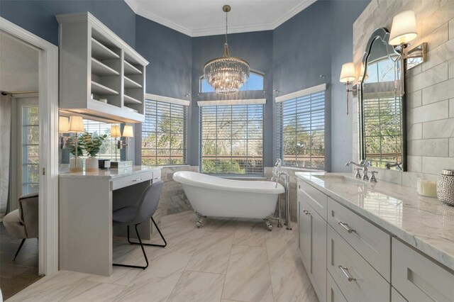 9288 Scenic Bluff Dr, Austin, TX 78733 - bathroom featuring a chandelier, a freestanding bath, vanity, marble look tiles, and crown molding