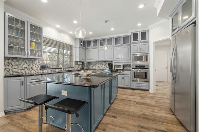 9288 Scenic Bluff Dr, Austin, TX 78733 - kitchen featuring appliances with stainless steel finishes, gray cabinets, ornamental molding, tasteful backsplash, and a sink