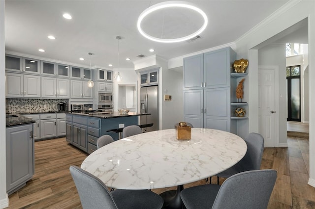 9288 Scenic Bluff Dr, Austin, TX 78733 - dining space featuring ornamental molding, wood finished floors, recessed lighting, and baseboards