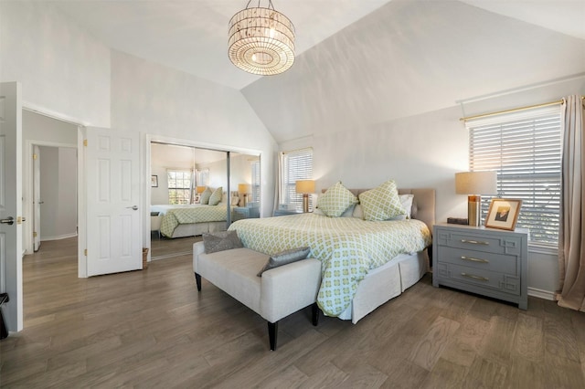 9288 Scenic Bluff Dr, Austin, TX 78733 - bedroom with a closet, wood finished floors, a chandelier, high vaulted ceiling, and baseboards
