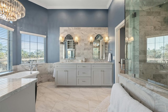 9288 Scenic Bluff Dr, Austin, TX 78733 - full bathroom featuring double vanity, a stall shower, ornamental molding, tile walls, and marble finish floors