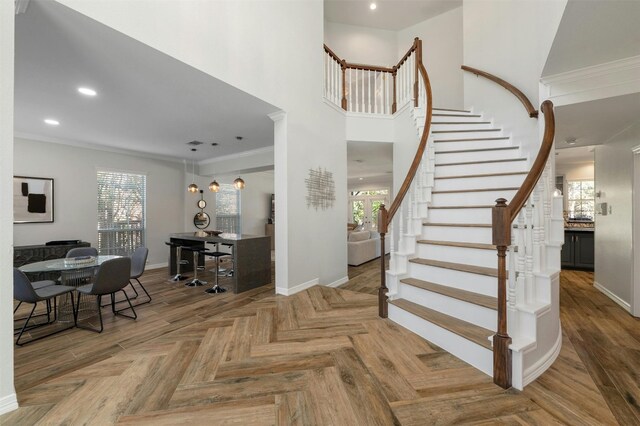 9288 Scenic Bluff Dr, Austin, TX 78733 - staircase featuring recessed lighting, ornamental molding, and a high ceiling