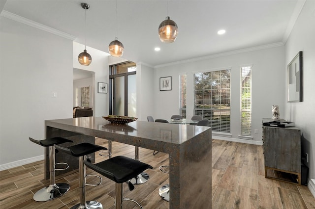 9288 Scenic Bluff Dr, Austin, TX 78733 - kitchen with light wood-style flooring, baseboards, crown molding, hanging light fixtures, and recessed lighting