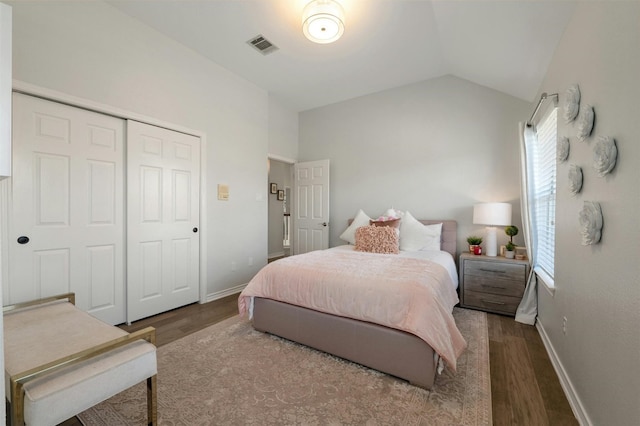 9288 Scenic Bluff Dr, Austin, TX 78733 - bedroom with wood finished floors, lofted ceiling, a closet, and baseboards