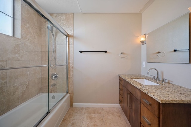 full bathroom featuring shower / bath combination with glass door, tile patterned floors, vanity, and baseboards