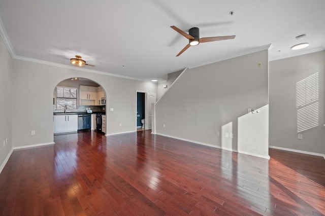 unfurnished living room featuring ceiling fan, ornamental molding, and dark wood-style flooring