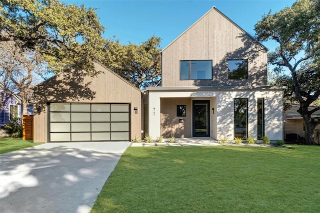 modern home featuring driveway, a garage, and a front yard