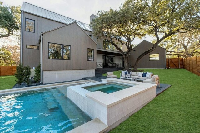 view of pool featuring a lawn, an in ground hot tub, an outdoor living space, and a fenced backyard