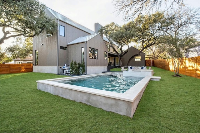 view of swimming pool featuring a fenced backyard, a fenced in pool, and a lawn