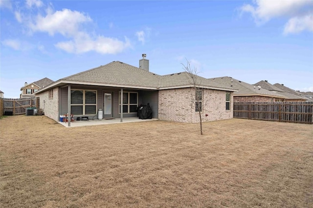 903 Mclaury Cv, Killeen, TX 76542 - rear view of house with a fenced backyard, a chimney, a patio area, and brick siding