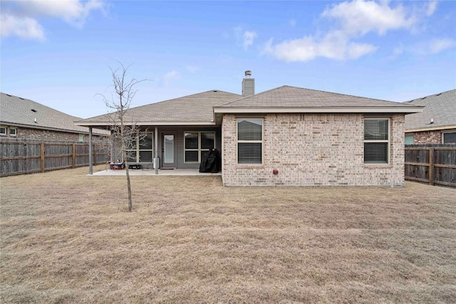 903 Mclaury Cv, Killeen, TX 76542 - rear view of property featuring a fenced backyard, a patio area, a chimney, and brick siding