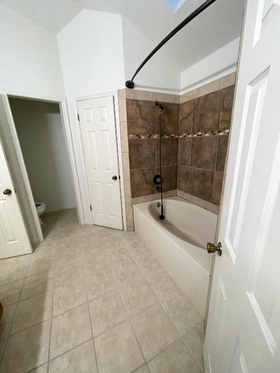 full bath with toilet, shower / washtub combination, and tile patterned floors