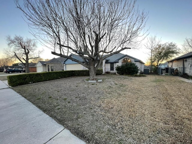 view of front of house with a front lawn and fence