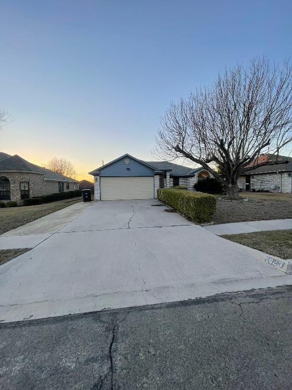 view of front of home featuring an attached garage and concrete driveway