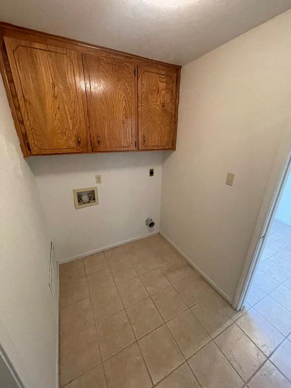 laundry room featuring washer hookup, cabinet space, hookup for an electric dryer, and baseboards