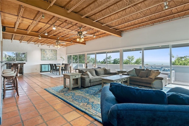 living area featuring a high ceiling, wooden ceiling, and tile patterned floors