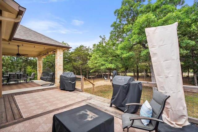 view of patio with a ceiling fan, grilling area, a deck, and outdoor dining space