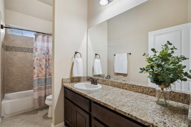full bathroom featuring vanity, shower / bathtub combination with curtain, tile patterned flooring, and toilet