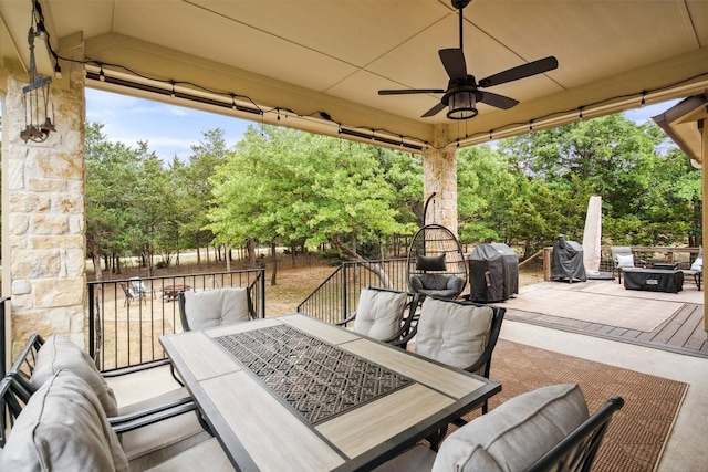 view of patio / terrace featuring outdoor dining area, ceiling fan, an outdoor fire pit, and fence