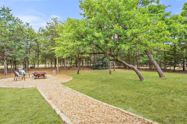 164 Abamillo Dr, Bastrop, TX 78602 - view of green lawn featuring an outdoor fire pit