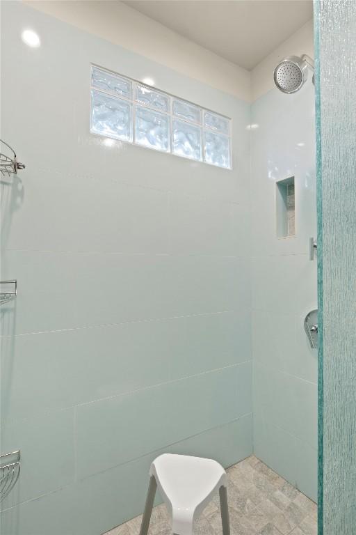 bathroom with tiled shower