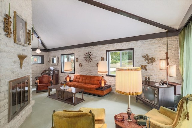 living area with vaulted ceiling with beams and a fireplace