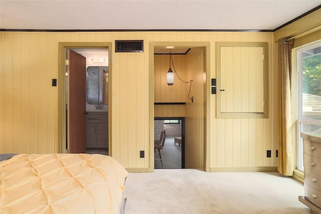 bedroom with visible vents, carpet flooring, and ornamental molding