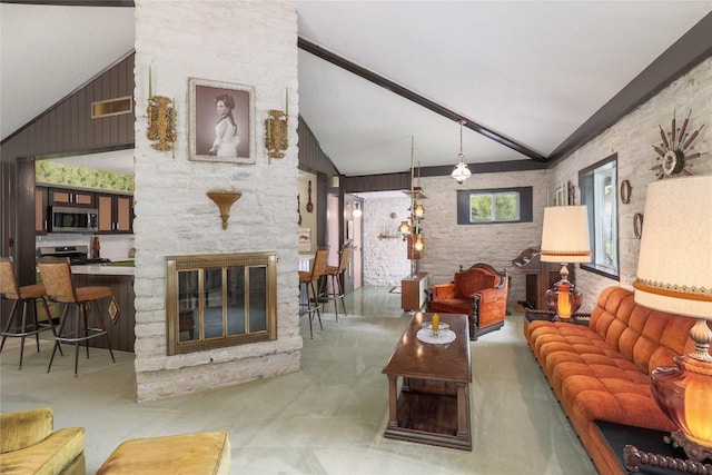 living room with high vaulted ceiling, visible vents, and a fireplace