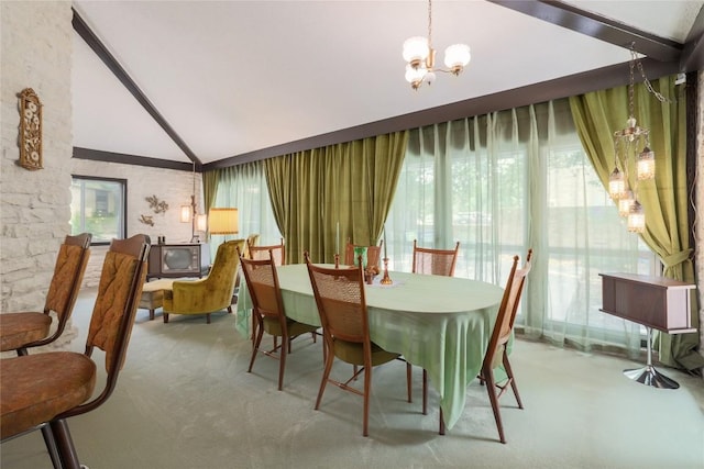 dining area with an inviting chandelier and vaulted ceiling