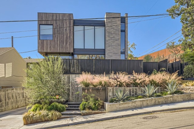 modern home featuring fence