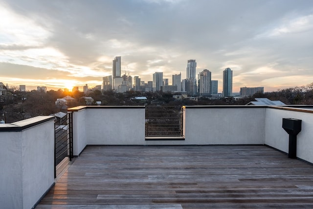 deck at dusk featuring a city view