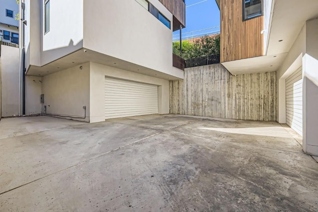 view of property exterior featuring driveway, a garage, and stucco siding