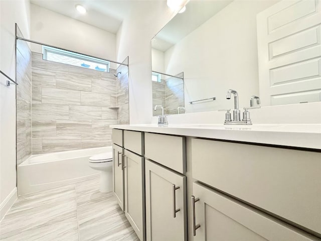 bathroom featuring double vanity, toilet, and shower / bathing tub combination