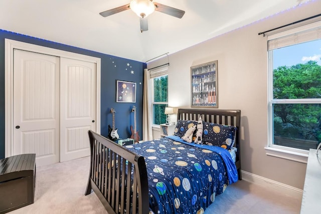 bedroom with baseboards, a ceiling fan, vaulted ceiling, carpet flooring, and a closet