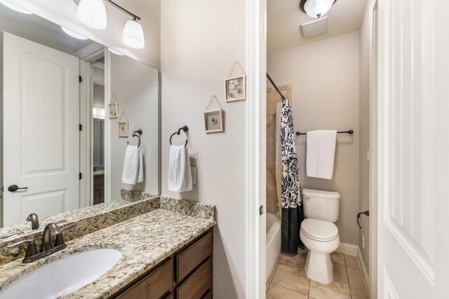 bathroom featuring baseboards, toilet, tile patterned flooring, shower / bathtub combination with curtain, and vanity