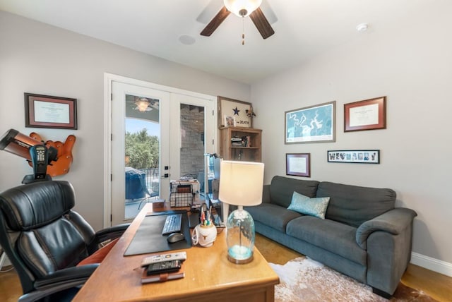 home office featuring french doors, a ceiling fan, and baseboards