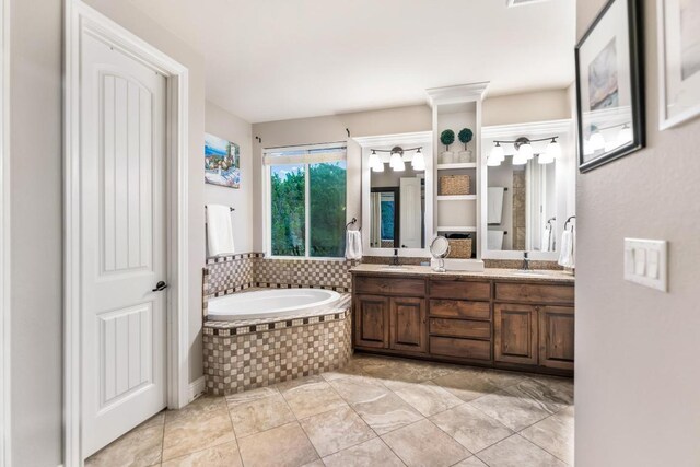 bathroom featuring double vanity, a sink, and a bath