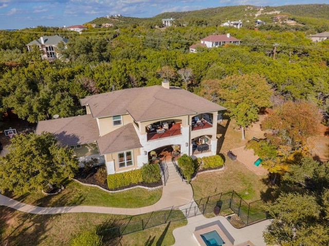 bird's eye view with a wooded view