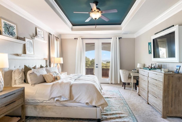 bedroom with light colored carpet, access to exterior, french doors, ornamental molding, and a raised ceiling