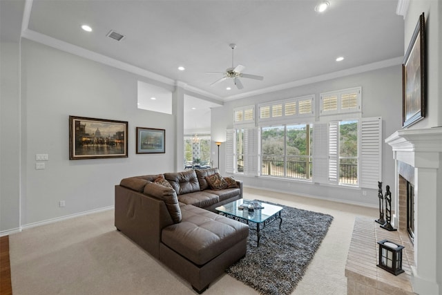 living area with visible vents, baseboards, crown molding, a fireplace, and recessed lighting