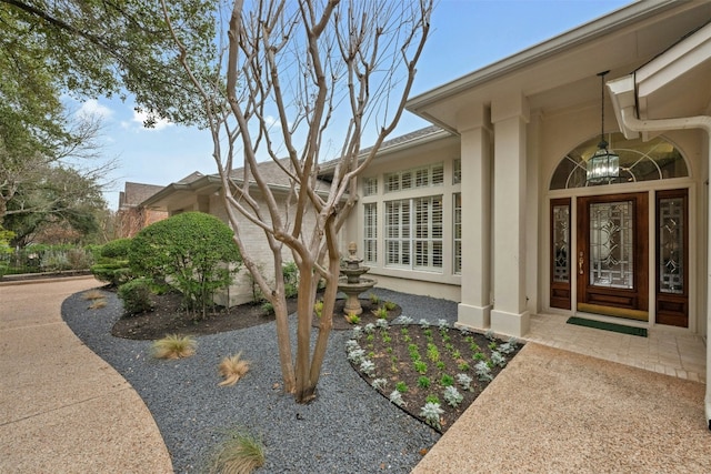 property entrance with stucco siding