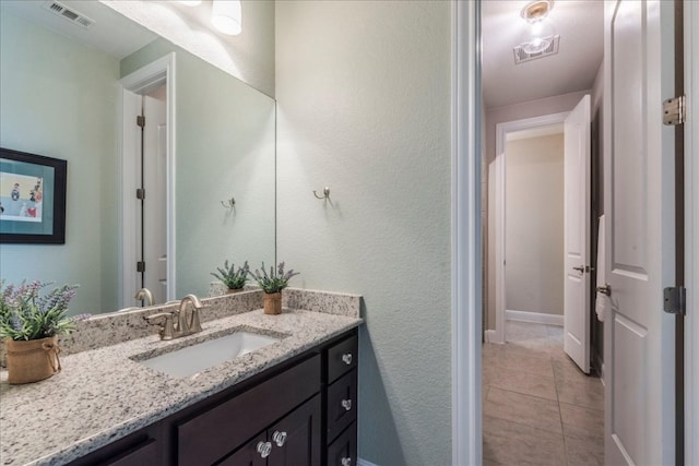 bathroom featuring vanity, visible vents, and tile patterned floors