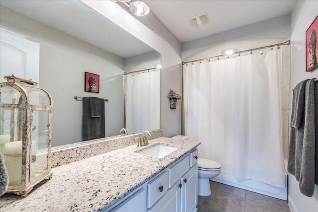 bathroom featuring shower / bath combo, visible vents, toilet, tile patterned floors, and vanity