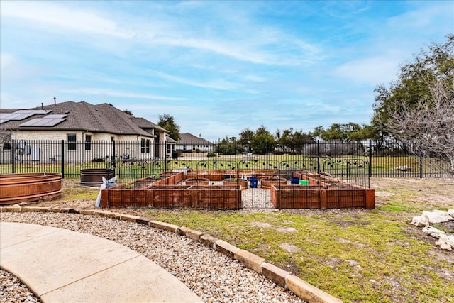 view of yard with fence and a vegetable garden