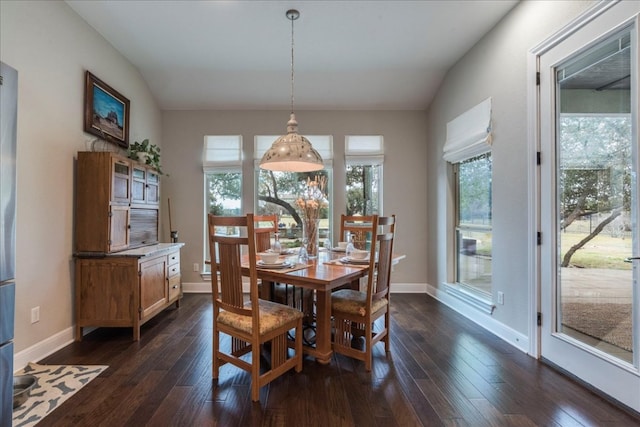 dining room with lofted ceiling, dark wood-style floors, and baseboards