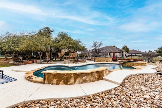 view of swimming pool featuring a patio area and a pool with connected hot tub