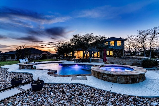 view of pool featuring a pool with connected hot tub, fence, and a patio