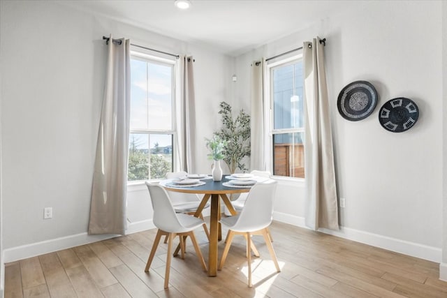 dining room with light wood-style flooring and baseboards