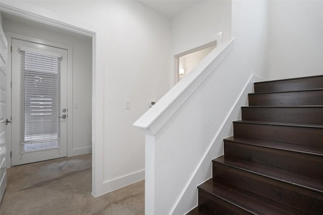 stairway with carpet flooring and baseboards